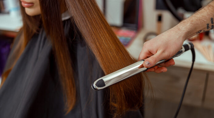 Why Choose a Hair Straightener for Smooth, Shiny Hair a hairdresser is using a hair straightener for a smoothy shiny look. Photo via vecteezy