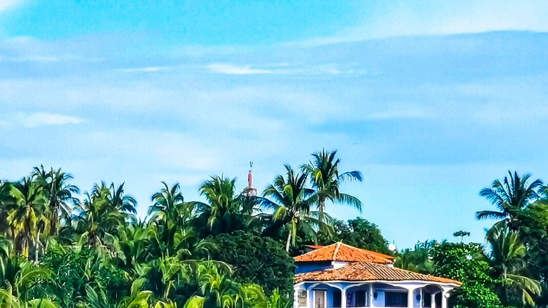 Hotels resorts buildings in paradise among palm trees Puerto Esc Hotels resorts and buildings in paradise among palm trees in Zicatela Puerto Escondido Oaxaca Mexico.