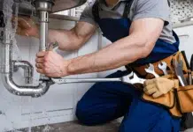 Best Plumbers Bring Precision That Keeps Every Home Flowing A Male plumber hand repairing a leaking sink pipe. Vecteezy-medium