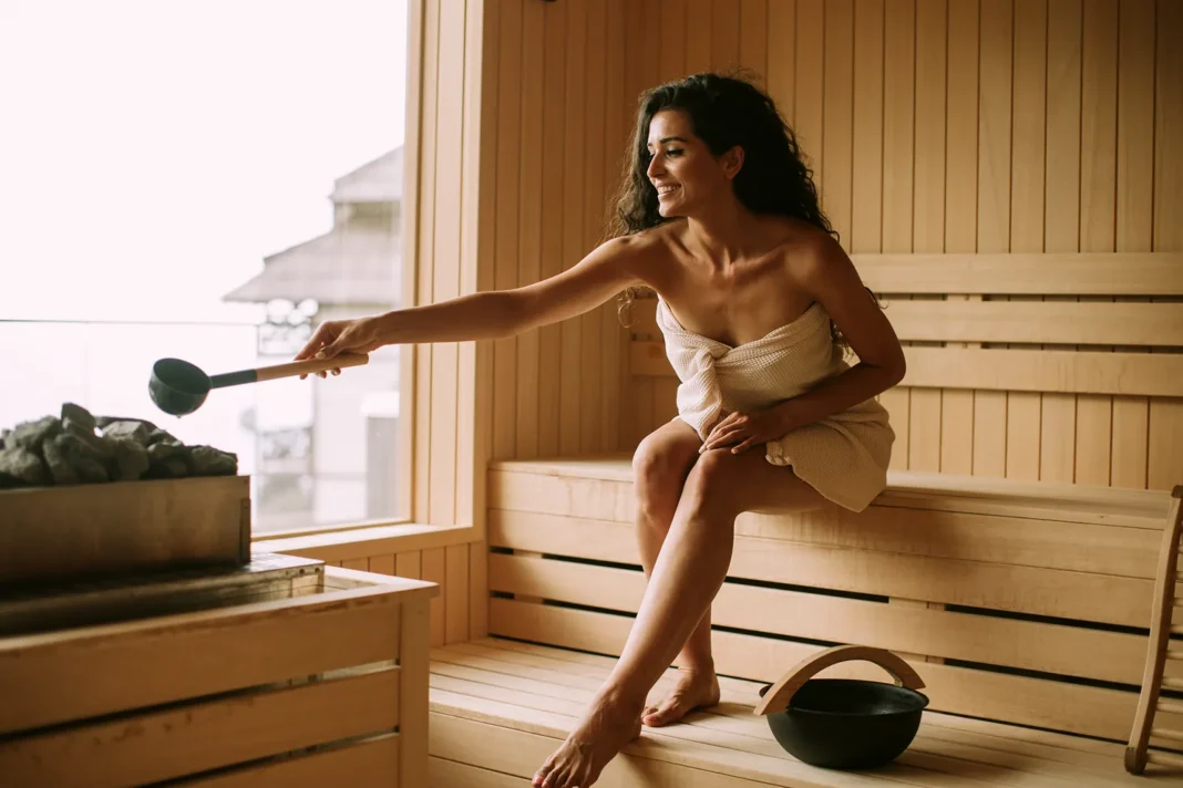 A young woman pouring water onto hot stone in her home sauna. Vecteezy-medium A young woman pouring water onto hot stone in her home sauna. Vecteezy-medium