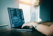Leveraging Web Scraping for Smarter Price Comparison a person doing web scraping on his computer. Vecteezy-medium