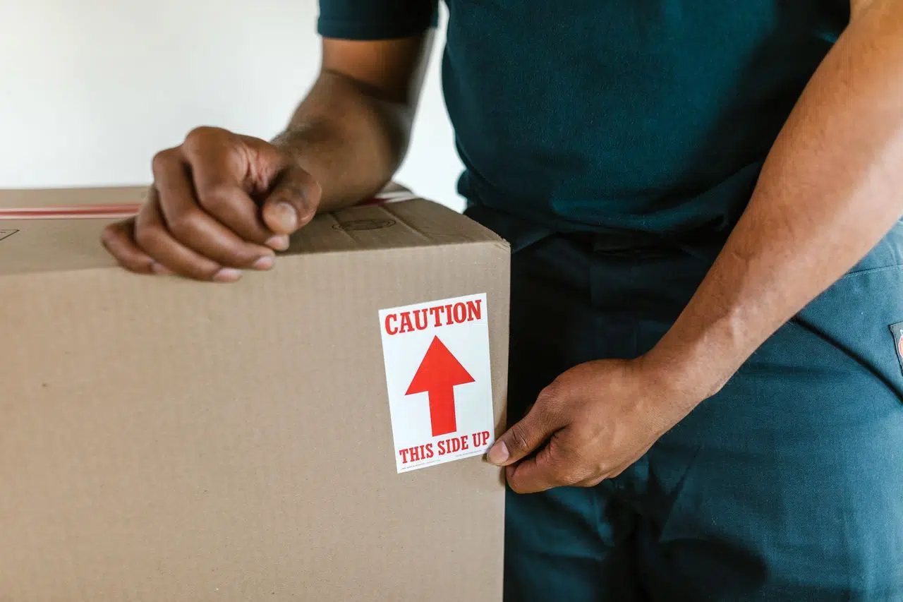 Professional movers carefully handling wrapped items Professional movers carefully handling wrapped items