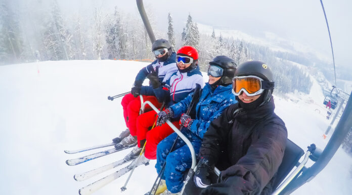 Everything You Need to Know Before Your First Ski Trip Four friends skiing, friends skiing in the mountains