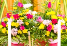The Most Elegant Flowers You Can Pick for Father’s Day A bouquet of pink roses arranged numerous decorations with candles and incense at a funeral.