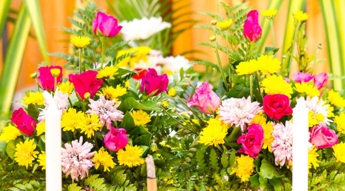 The Most Elegant Flowers You Can Pick for Father’s Day A bouquet of pink roses arranged numerous decorations with candles and incense at a funeral.