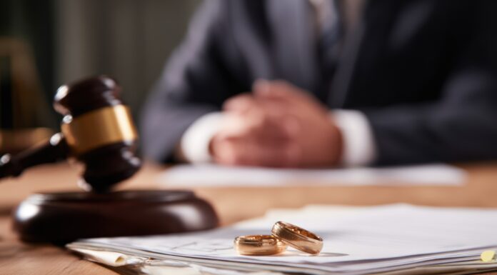 Questions to Ask Before Hiring a Divorce Lawyer Wedding rings and judge hammer on legal documents