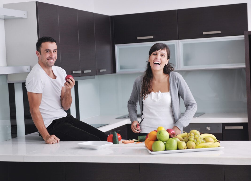 young couple have fun in modern kitchen young couple have fun in modern kitchen