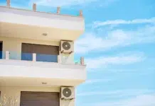 Benefits Of Using A Window Air Conditioning Unit For Home Cooling modern building with air conditioning units and balconies. Vecteezy-medium