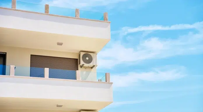 Benefits Of Using A Window Air Conditioning Unit For Home Cooling modern building with air conditioning units and balconies. Vecteezy-medium