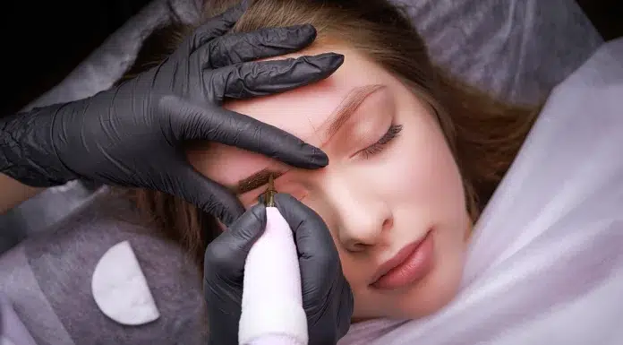 Eyebrow Tattoo: Everything You Need to Know Before Getting One Performing Eyebrow Tattoo services to a client. Vecteezy-medium