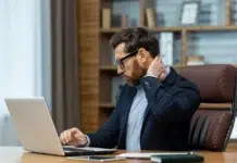 Can Jaw Tension Cause Neck Pain? a mature business man with neck pain. Vecteezy-medium