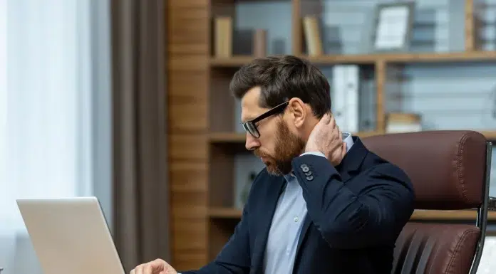 Can Jaw Tension Cause Neck Pain? a mature business man with neck pain. Vecteezy-medium