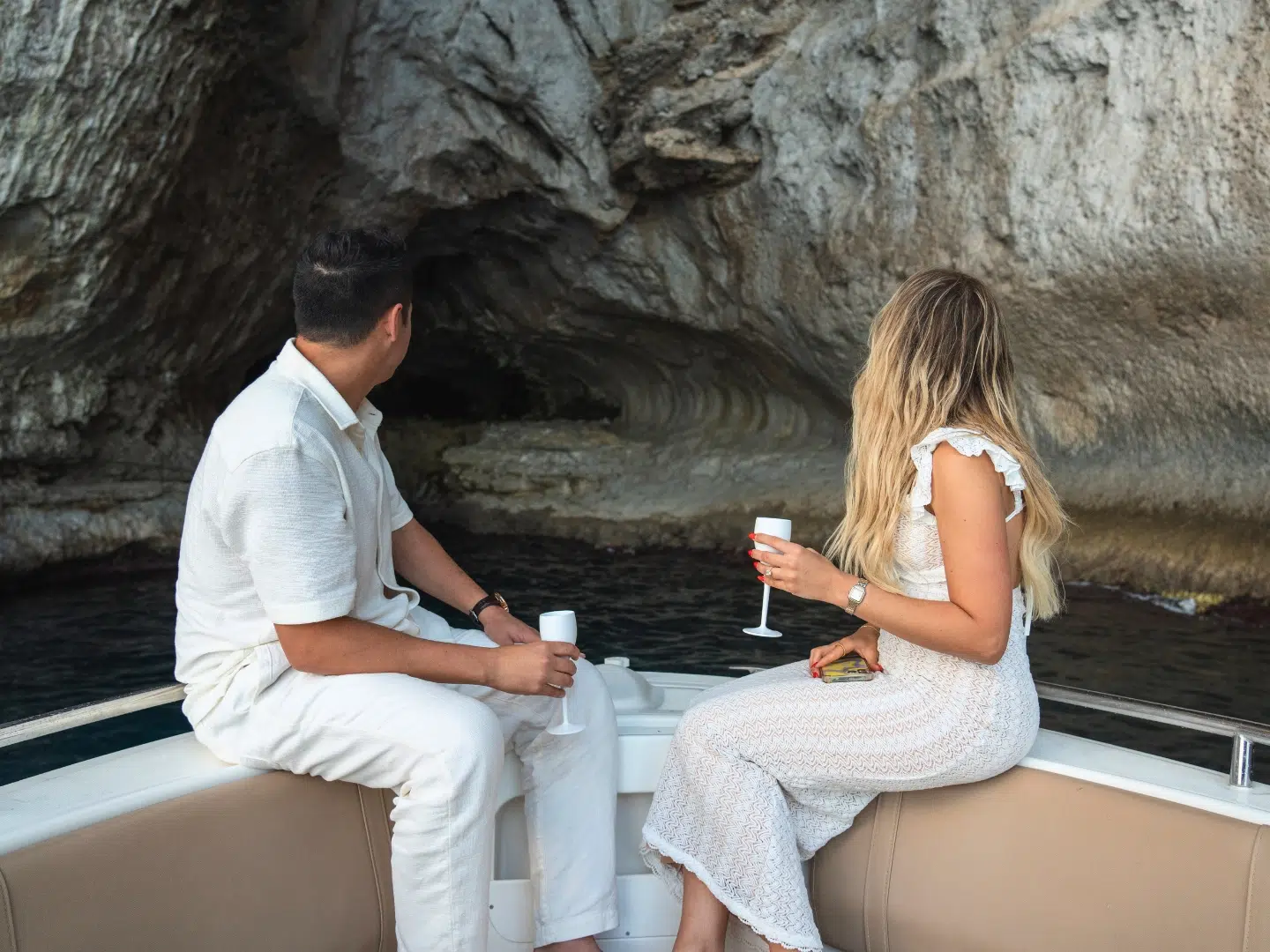 Couple exploring sea cave on a private pdg boat tour in the Sorrento Peninsula, Amalfi Coast Couple exploring sea cave on a private pdg boat tour in the Sorrento Peninsula, Amalfi Coast