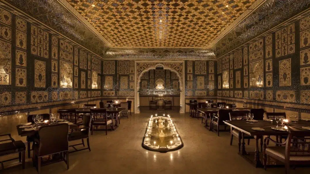 A wide view of Jamavar Jaipur’s no-electricity dining room reveals the dramatic interplay of candlelight, handcrafted surfaces and regal symmetry. A wide view of Jamavar Jaipur’s no-electricity dining room reveals the dramatic interplay of candlelight, handcrafted surfaces and regal symmetry.