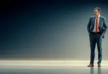 Why Standing All Day Is as Demanding as Sitting? A Confident business men standing all day. Vecteezy-medium