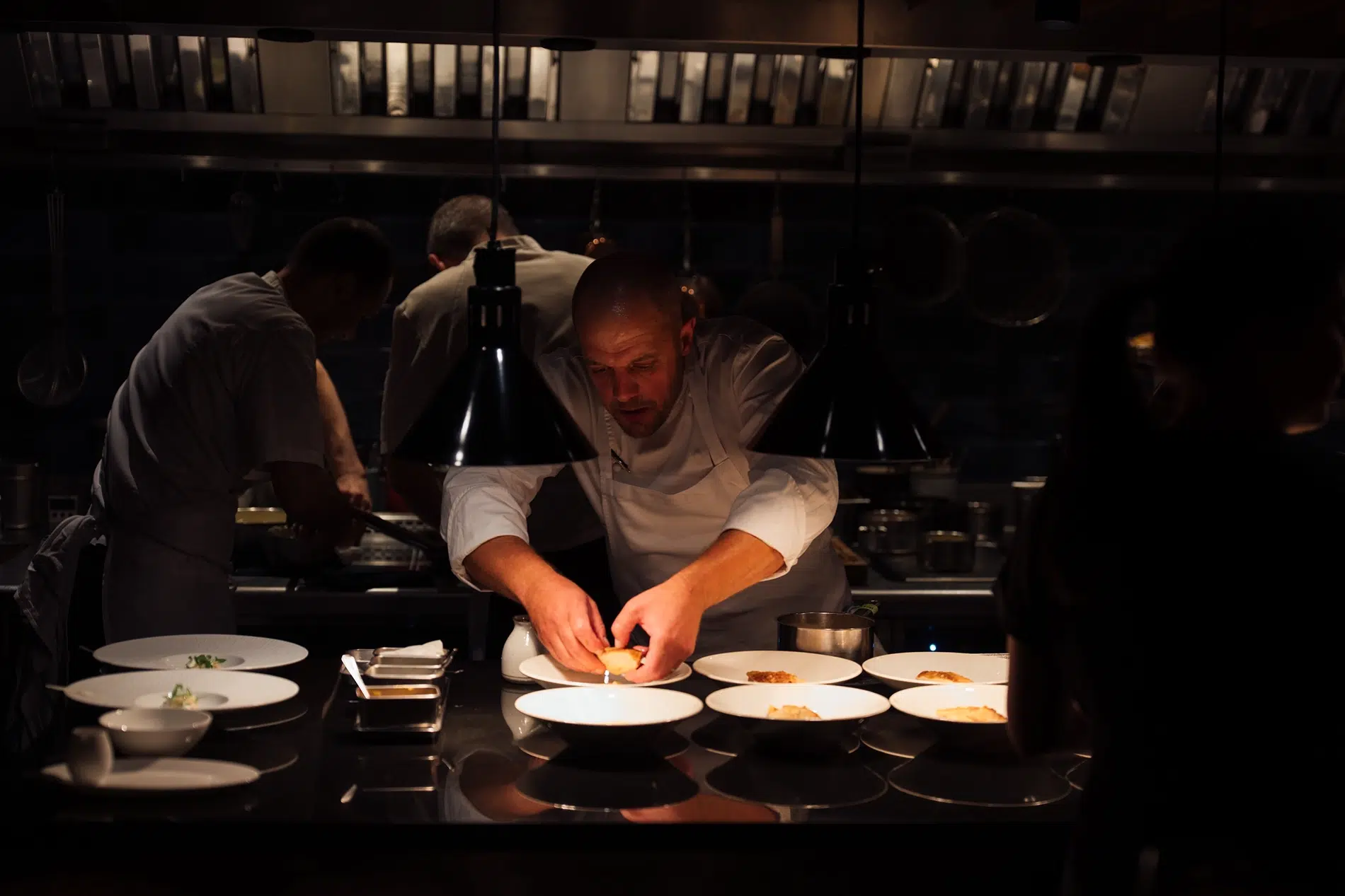 James Knappett at work in the Kitchen Table kitchen, where the two-Michelin-starred chef is known for precise, season-led cooking and meticulous presentation. James Knappett preparing dishes in the Kitchen Table kitchen