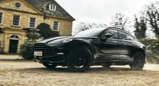 Aston Martin DBX driving outside a country estate in MobLand Season 2