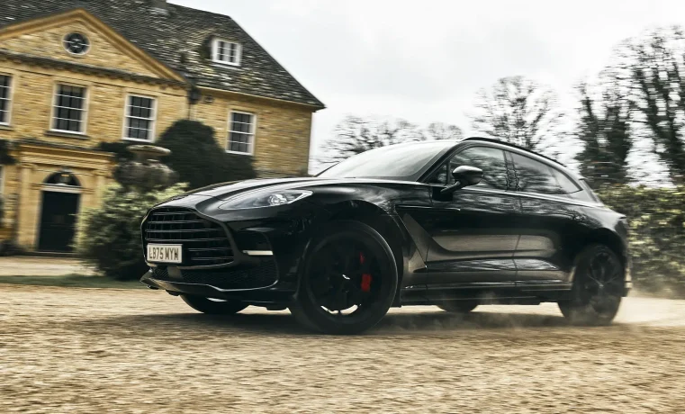 Aston Martin DBX driving outside a country estate in MobLand Season 2