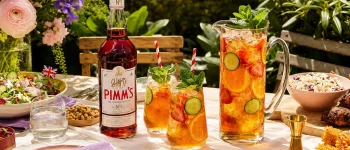 Pimm’s summer cup served with fruit at an outdoor garden table