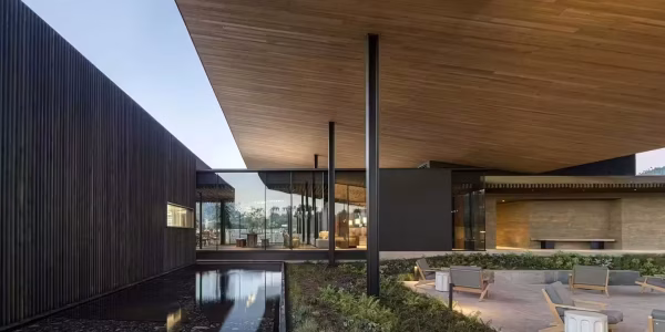 a-modern-architectural-image-with-a-shallow-pool-and-a-patio-set-with-chairs